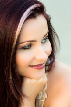 Portrait about a beautiful smiling woman with red hair.