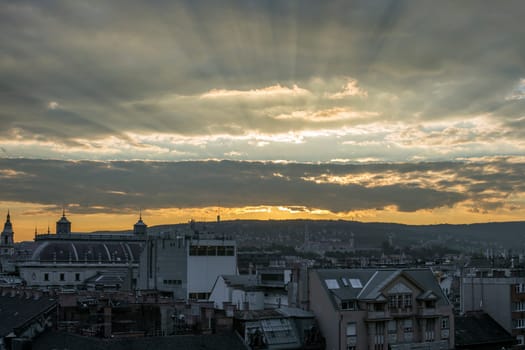 Budapest city landscape with cloudy sky at sunset.
