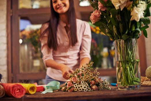 Woman making bouquet of different flowers