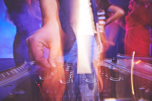 Hand of dj adjusting sound