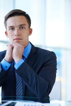 Young businessman looking at camera