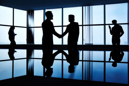 Silhouettes of business people in office
