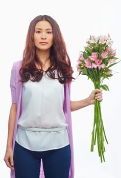 Pretty brunette with bunch of white and pink amaryllises looking at camera