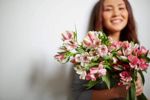 Fresh amaryllises held by happy girl