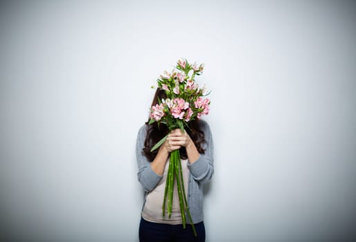 Young woman behind big bouquet