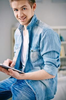 Young smiling man using touchpad