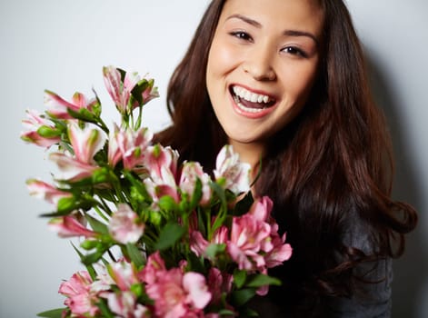 Cheerful female with bunch of pink flowers
