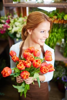 Happy florist or gardener holding bunch of tulips