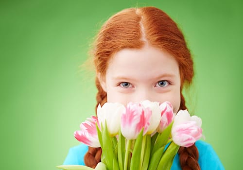 Close-up of a girl smelling bunch of tulips