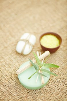 Toilet soap, bath salt and cosmetic sticks on wattled rug