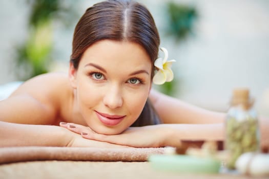 Relaxed female lying in spa salon