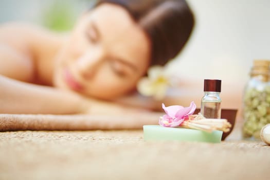 Products for beauty care with relaxed female on background