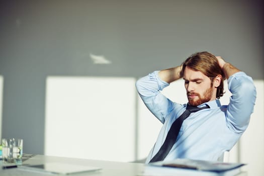Office worker taking a pause at his workplace