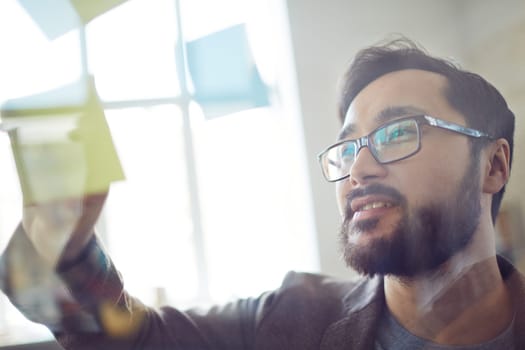 Young modern businessman writing his working plan