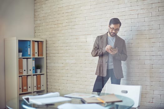 Young businessman writing plan of work in office