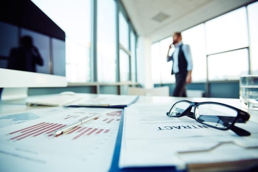 Man walking in his office with contract left on table