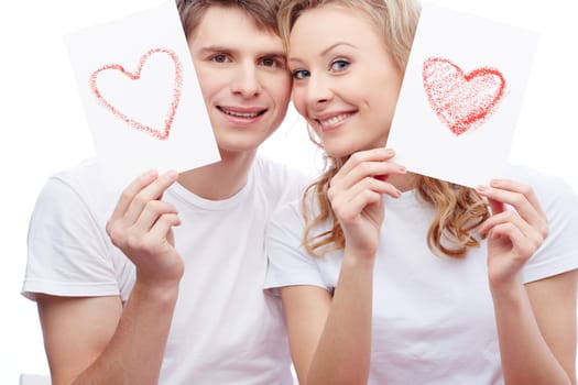 Portrait of couple with painted hearts on papers
