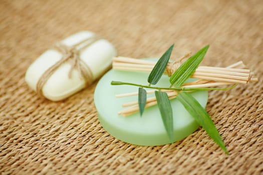 Toilet soap and wooden cosmetic sticks on wattled rug