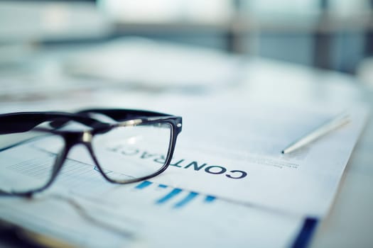Close-up of a contract and glasses