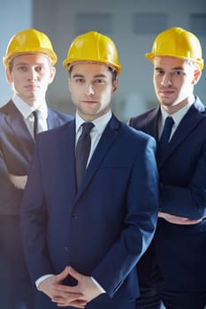 Portrait of three confident men in hardhats