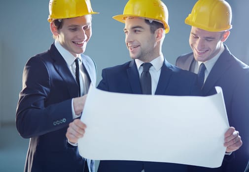 Positive engineers examining blueprint
