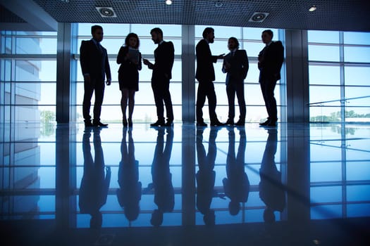 Group of business people communicating in the hall