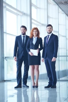 Team of three friendly businesspeople