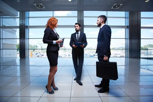 Three business people meeting in the hall