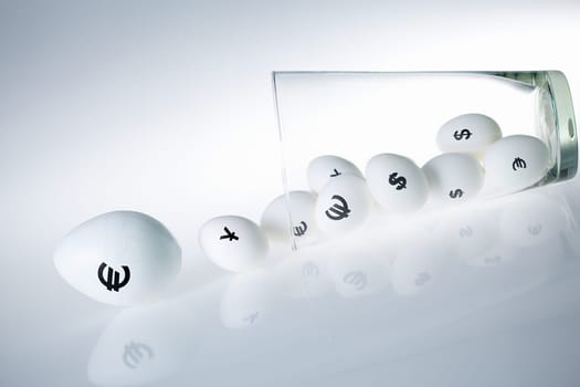 Eggs with currencies rolling to nowhere