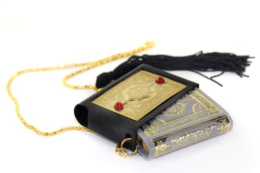 a Koran with a cover and chain