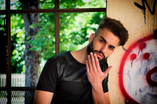 Handsome young man with beard looking at camera