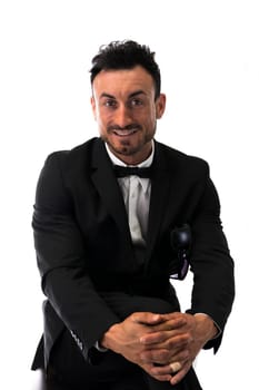 Handsome young man with suit and bowtie isolated on white, looking at camera