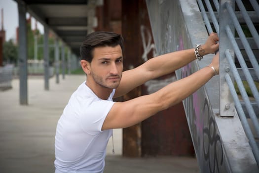 Handsome man outdoor in urban environment looking at camera
