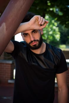 Handsome young man with beard looking at camera