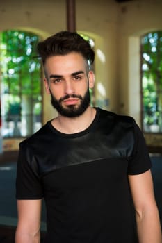 Handsome young man with beard looking at camera