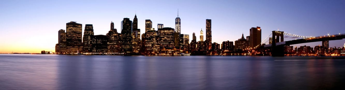 Twilight as the sun sets over Lower Manhattan. Famous New York landmarks.