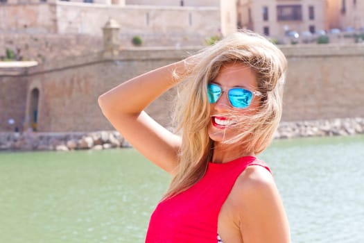 Young blonde woman with sunglasses in Palma de Mallorca