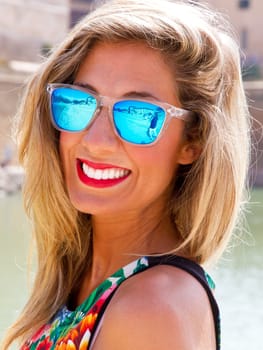 Young blonde woman with sunglasses in Palma de Mallorca