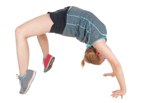 A lovely young woman making a bridge backwards in her gymnastic .exercise in shorts and seekers, isolated for white background.