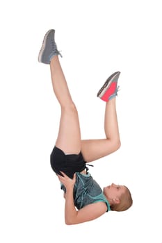 A lovely young woman in shorts an top and running shoes lying on the.floor doing aerobics exercise, isolated for white background.