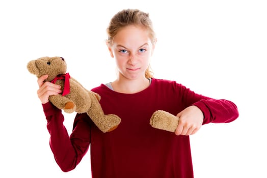 angry blond girl with broken teddy bear in front of white background