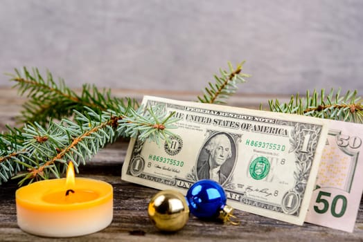 christmas sill with money, fir branch and candle