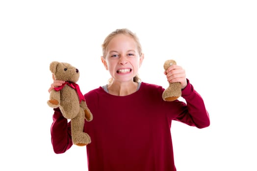 angry blond girl with broken teddy bear in front of white background