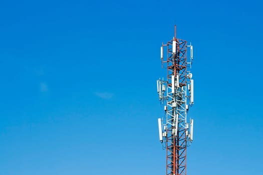 Mobile phone communication tower transmission  signal with blue sky background and antenna