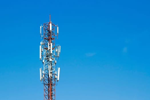 Mobile phone communication tower transmission  signal with blue sky background and antenna