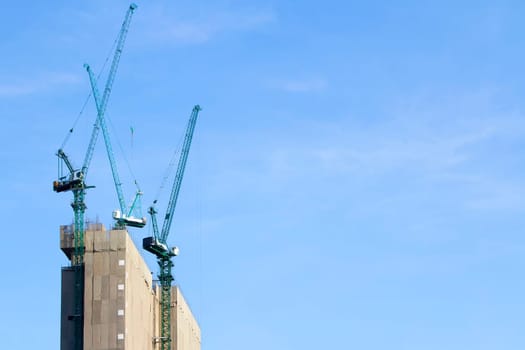 building site with cranes and blue sky