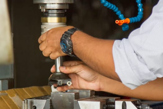 Man set up tooling insert to holder of milling  for work metal  after cutting