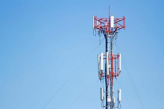 Mobile phone communication tower transmission  signal with blue sky background and leash