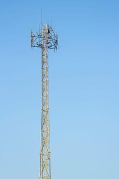 Mobile phone communication tower transmission  signal with blue sky background and antenna