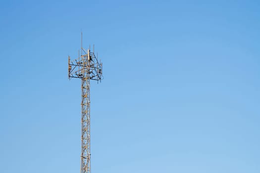 Mobile phone communication tower transmission  signal with blue sky background and antenna